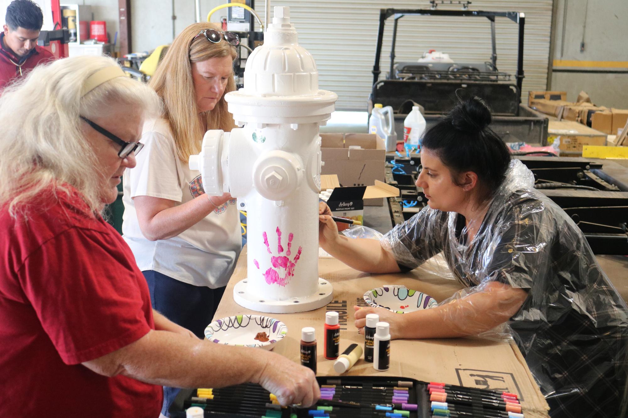 Wendy, Leighanna and Cynthia painting the fire hydrant