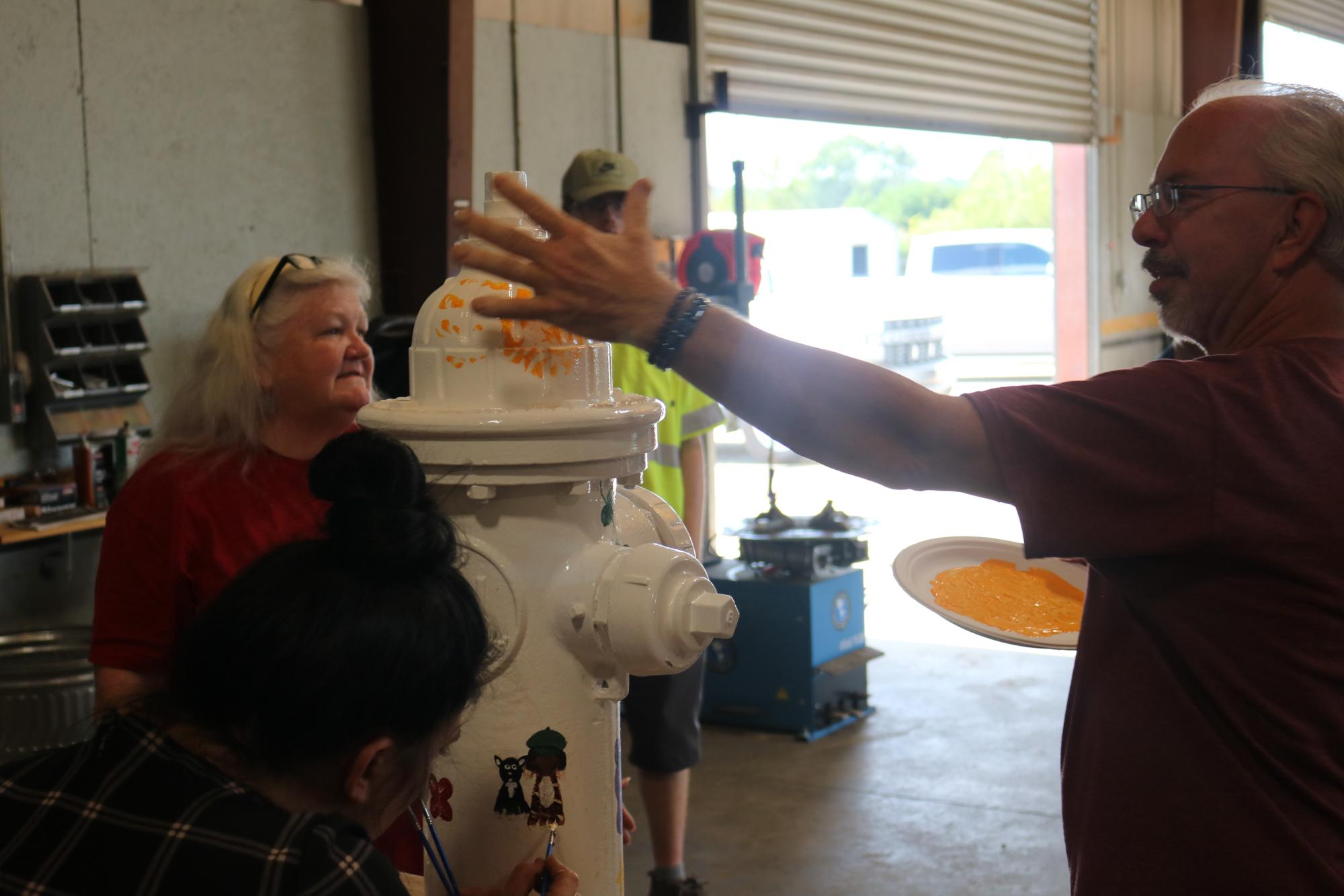 Tony adding his hand print to the fire hydrant