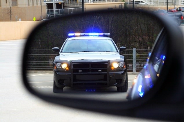 Police car in rearview mirror