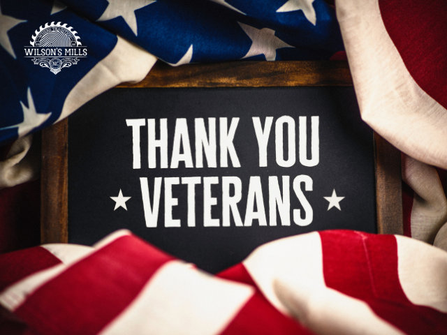 Folded American flags surrounding chalkboard with thank you 